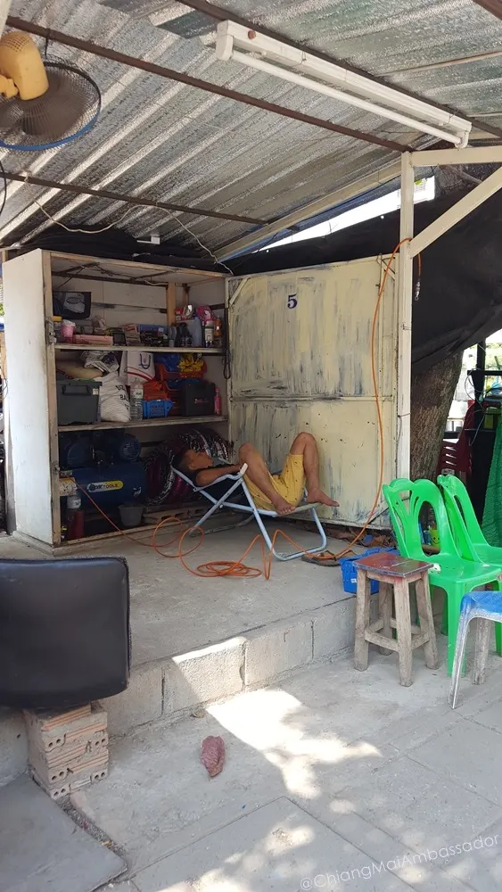 Roadside tyre repair shop with mechanic resting
