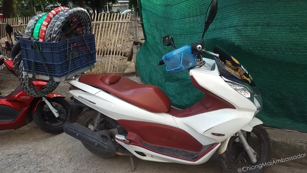 Spare motorbike tyres loaded on a crate for mobile repairs