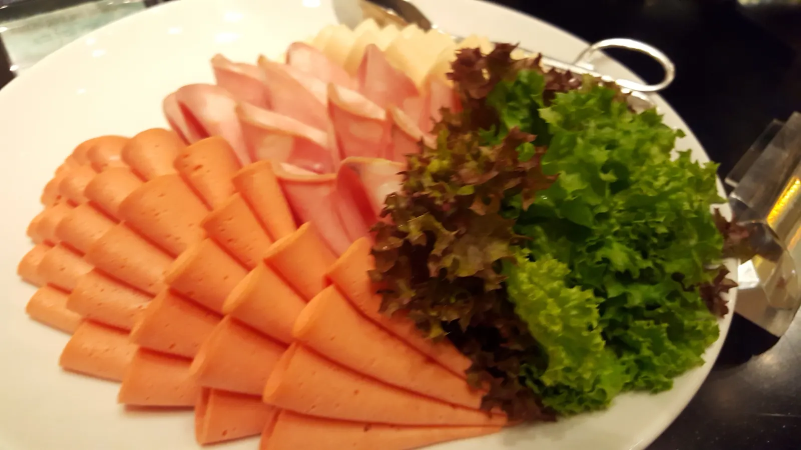 Cold cuts and cheese platter with salad greens