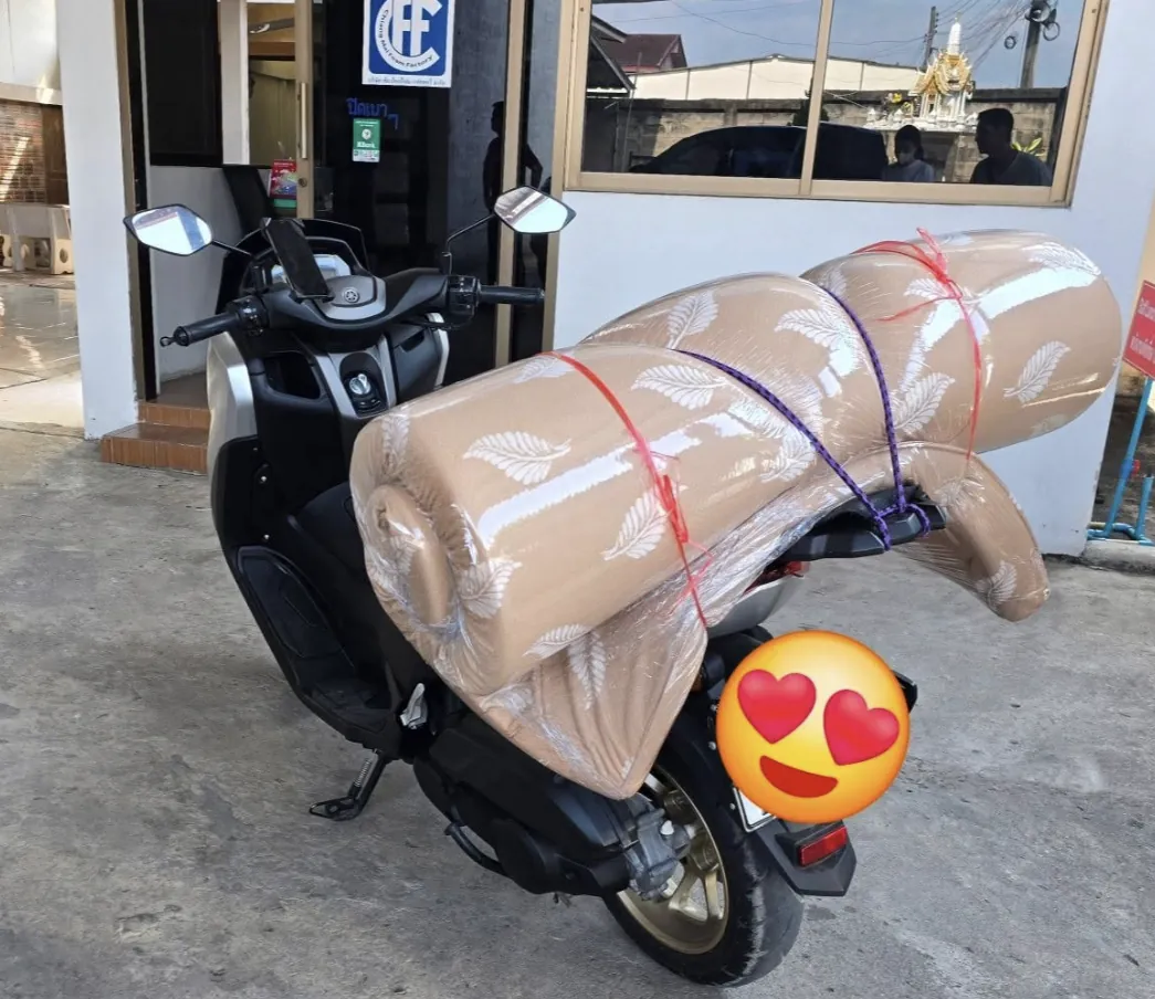 Custom mattress rolled and strapped to a motorbike for delivery in Chiang Mai