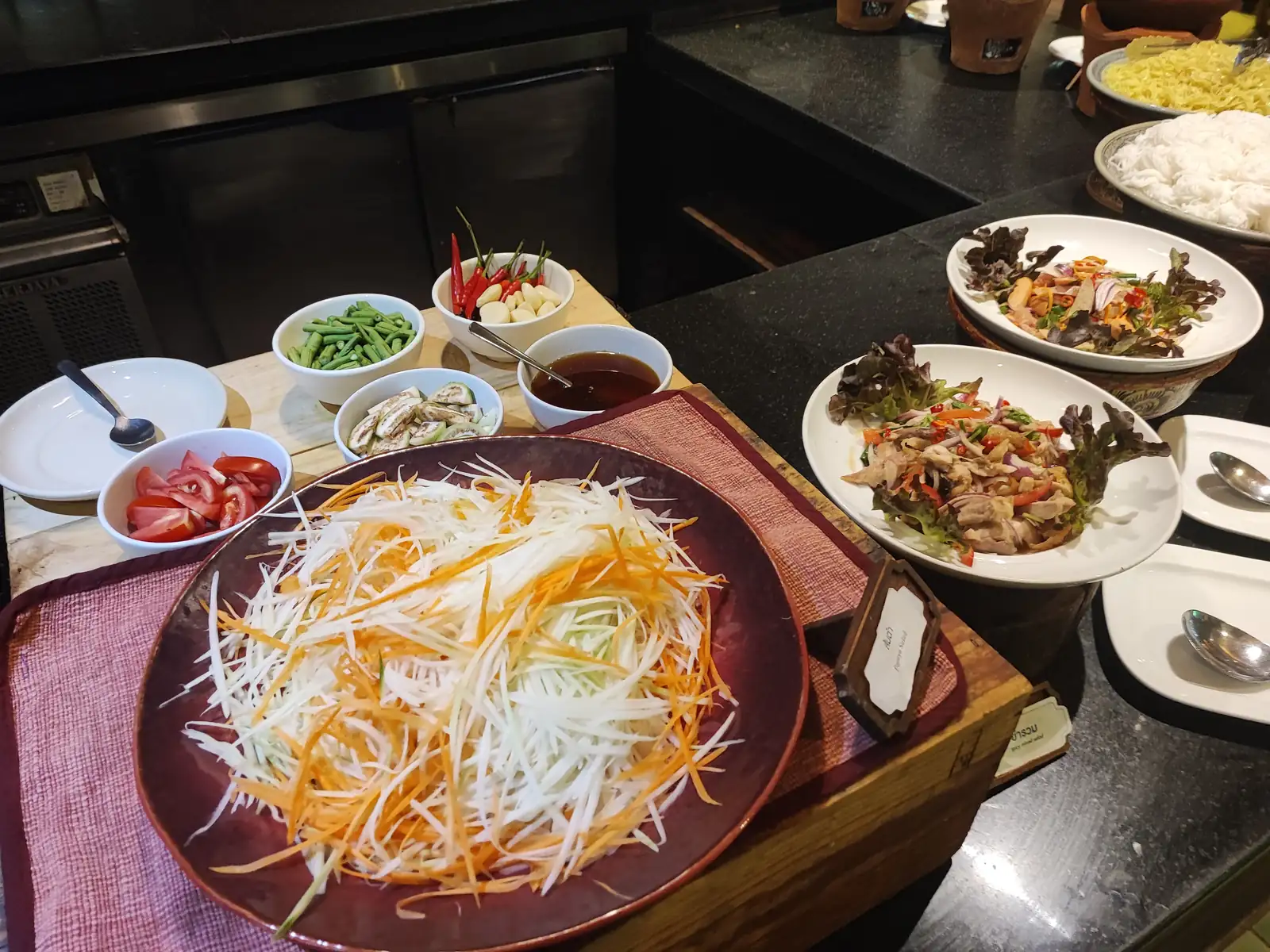Fresh salad bar with som tam and Thai chicken salad