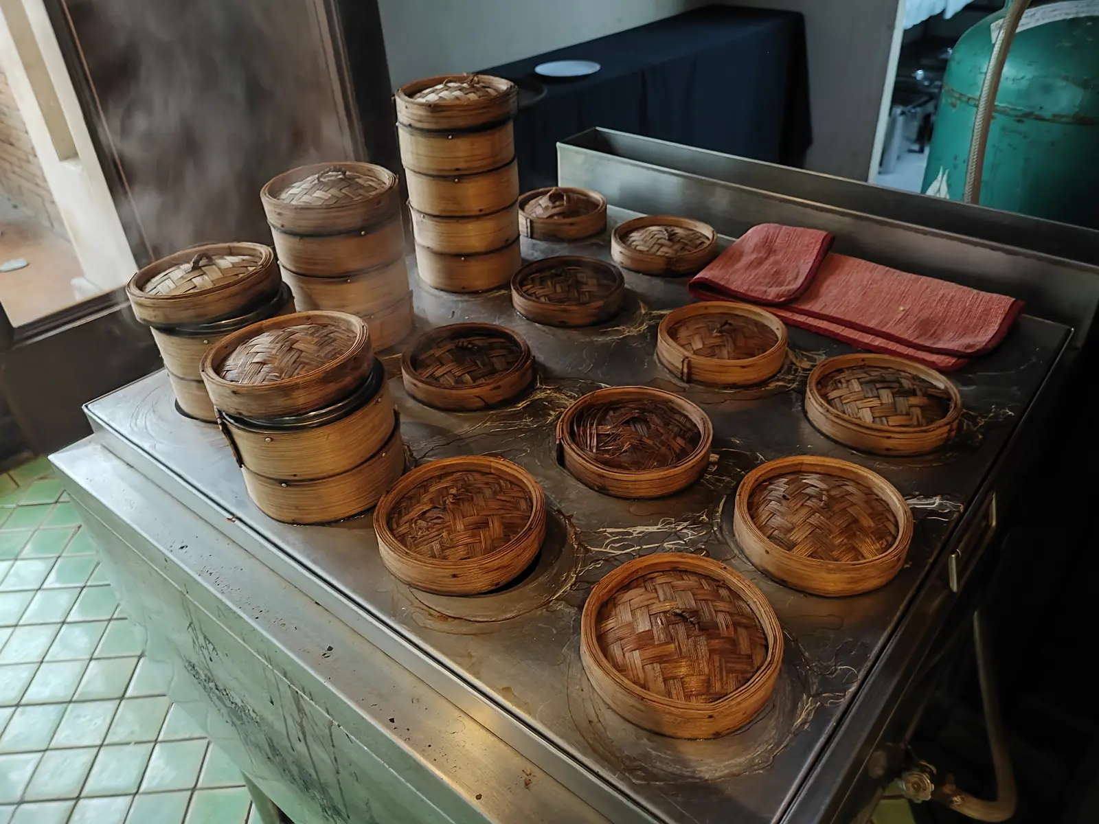 Stacked bamboo steamer baskets at the dim sum station