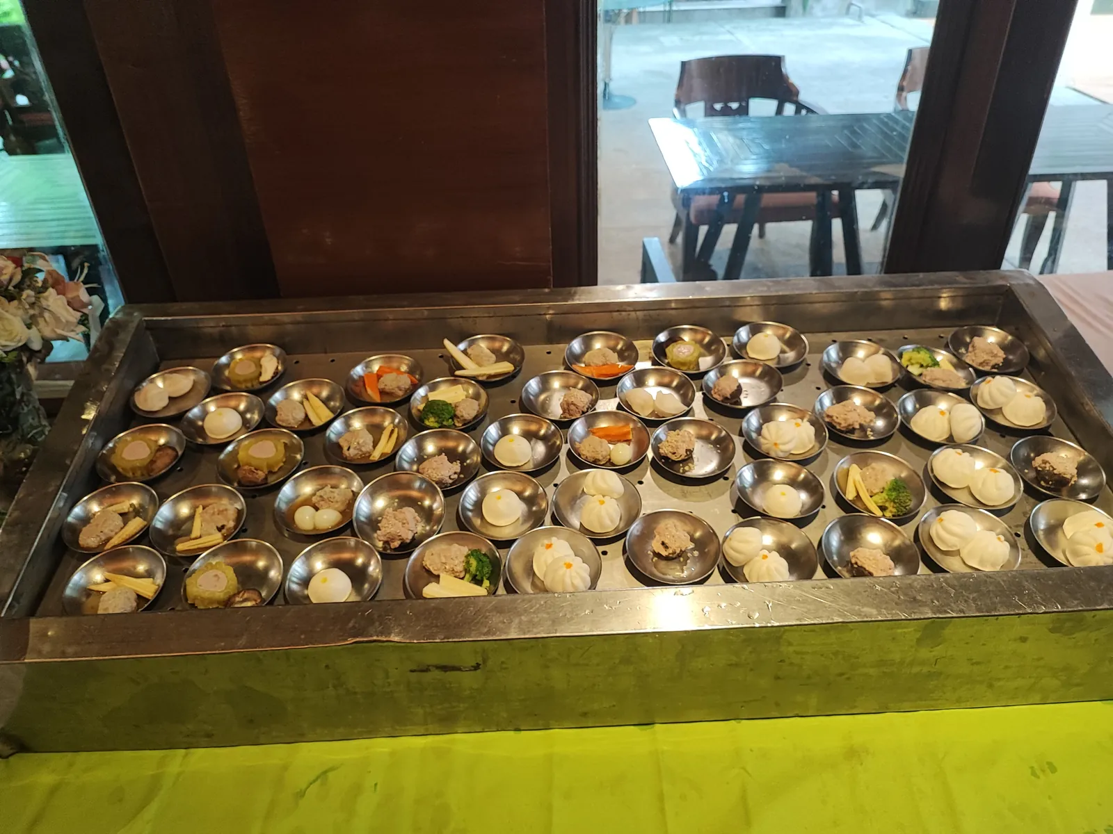 Assorted dim sum bites plated on small dishes