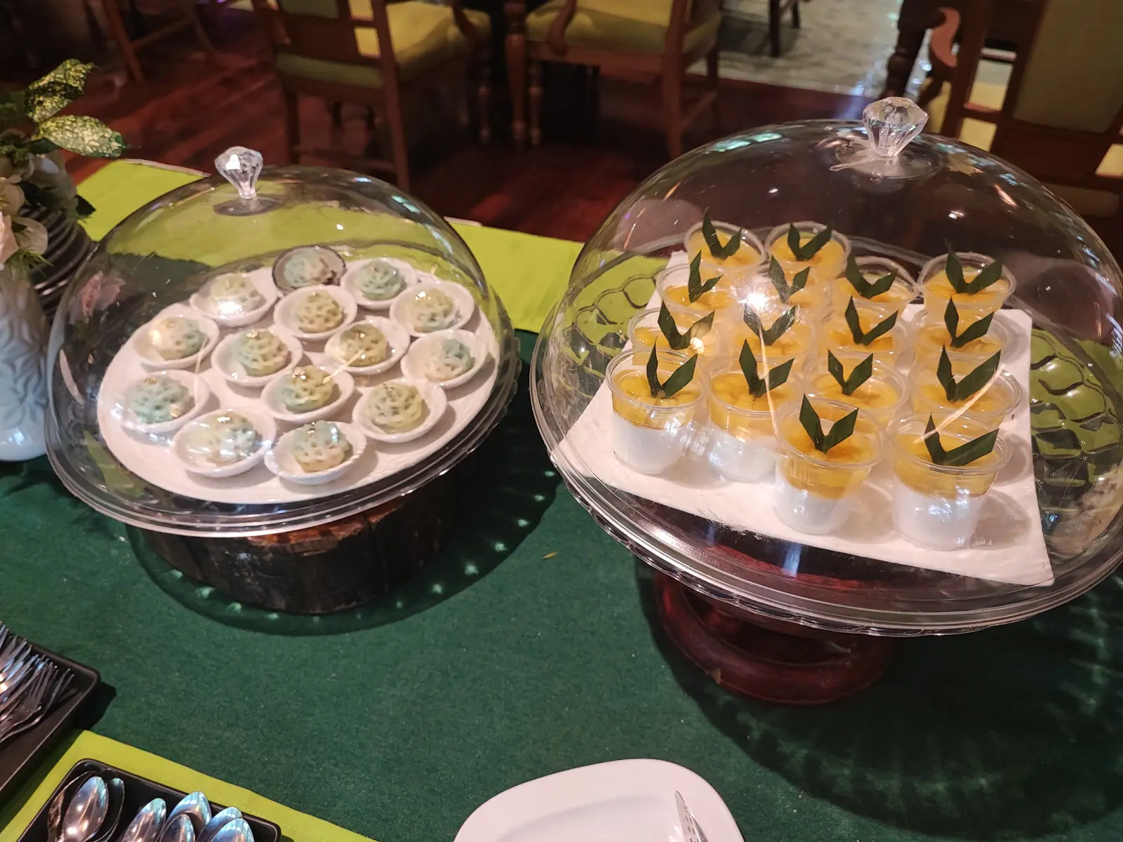 Bite-sized desserts under glass domes on the dessert table