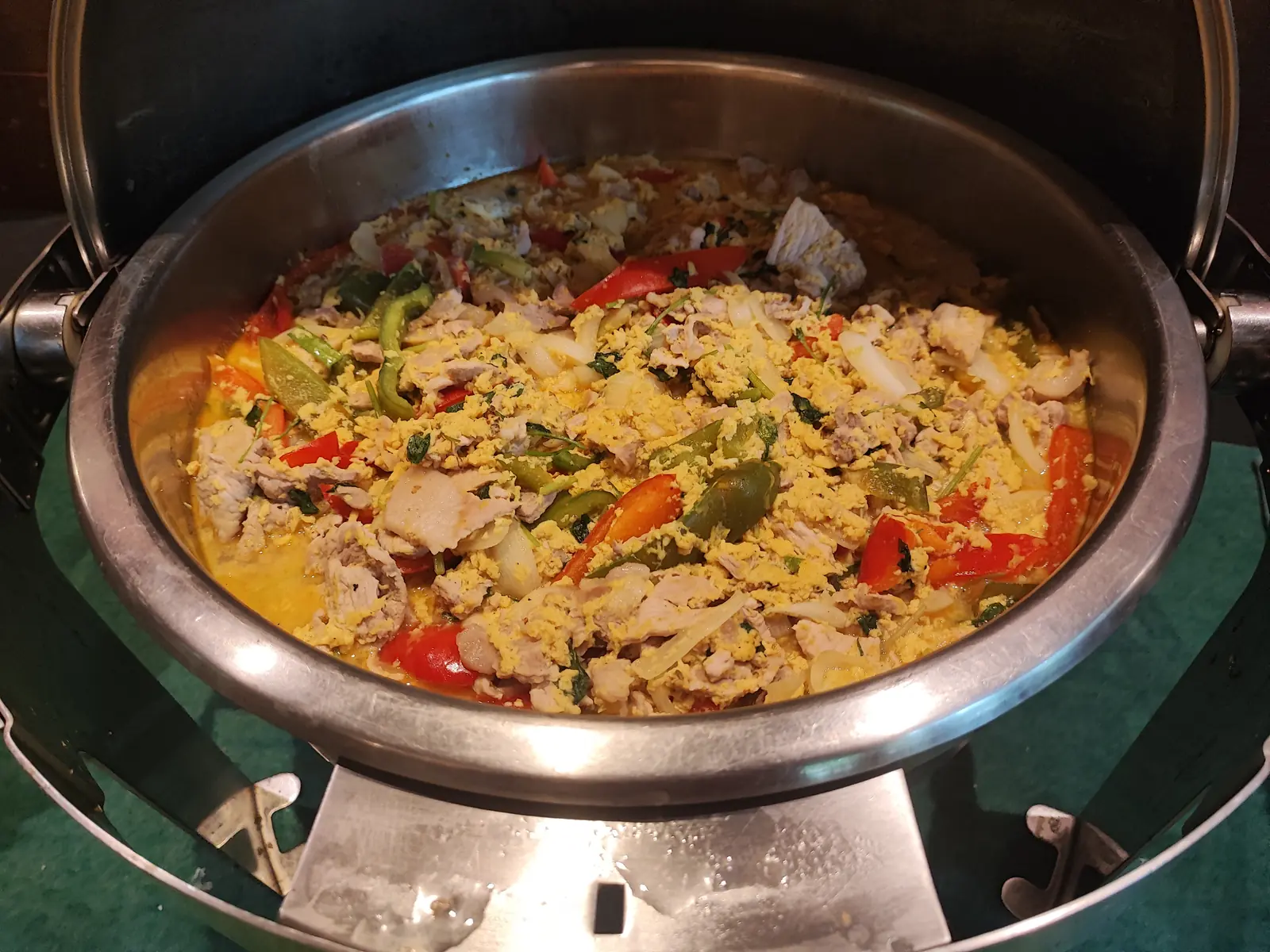 Chicken and pepper stir-fry cooking in the chafing dish