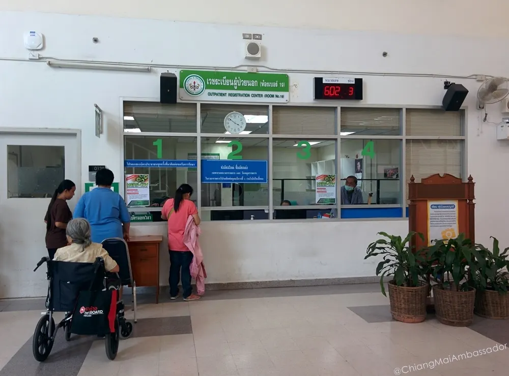 Outpatient registration counters with a patient waiting in a wheelchair