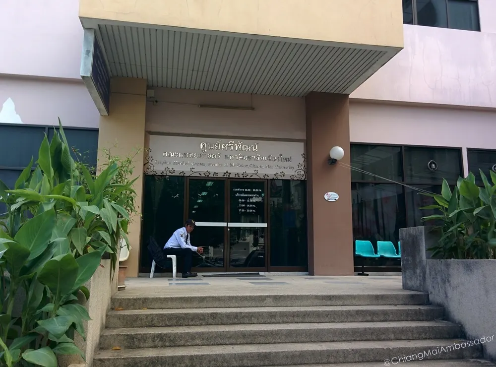 Sriphat Medical Center entrance doors with a security guard seated